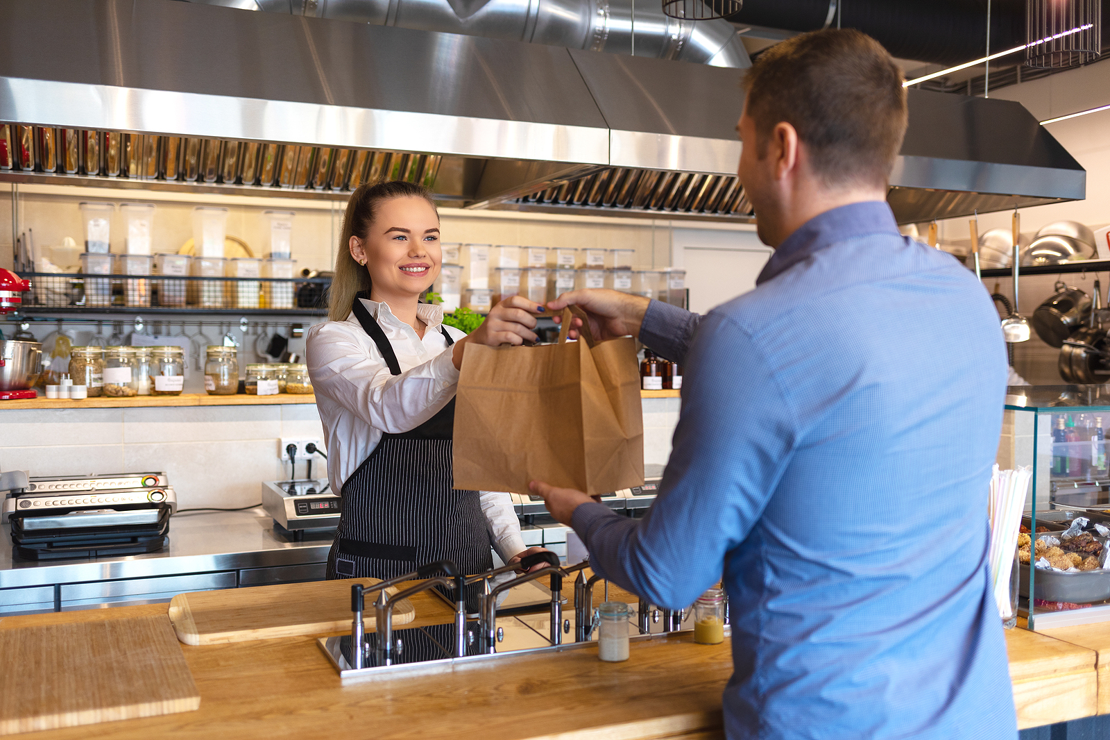 bigstock Smiling Young Waiter Giving Fo 282097294 1