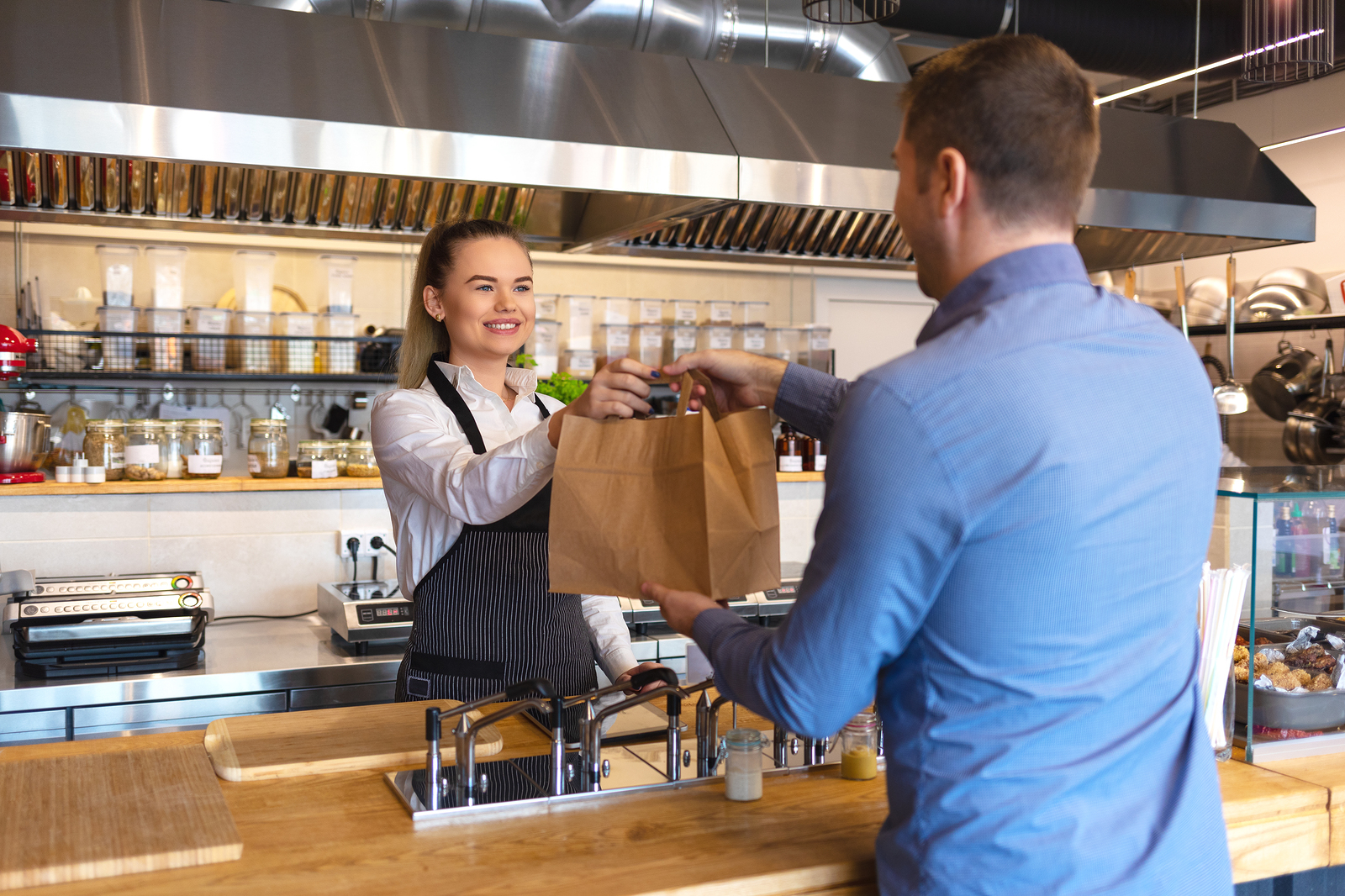 bigstock Smiling Young Waiter Giving Fo 282097294