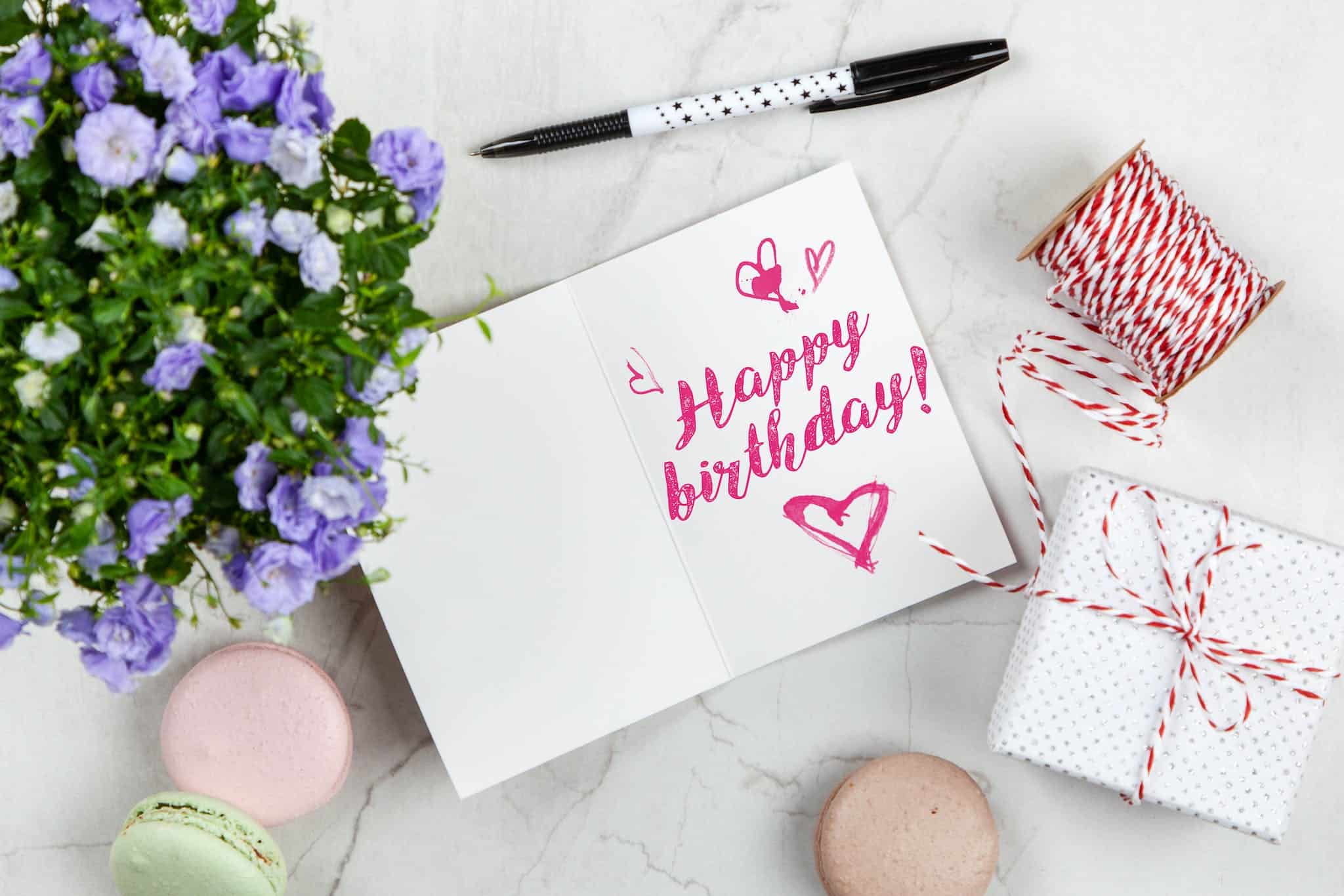 Happy Birthday Card Beside Flower, Thread, Box, and Macaroons Spot UV Coated Postcards